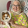 Shawnee is registered to the contest to win money with this photo: elderly_woman, glasses, neck_brace, armchair, blanket, small_dog, dog_cone, yellow_shirt, floral_pattern, indoor, smile, comfort, pet, human, seated, companion, happy, skin, hand, furniture