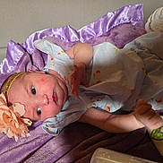 Araylia joined the competition — help win amazing prizes! baby, infant, child, headband, flower, blanket, purple, blue_eyes, cute, clothing, soft, lying_down, fabric, indoors, newborn, peaceful, small_hand, portrait, sleepwear, cozy