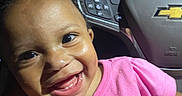 Nalanni is registered to the contest to win money with this photo: baby, child, infant, smiling, happy, portrait, car, car_interior, car_seat, dashboard, steering_wheel, pink_shirt, floral_design, flowers, teeth, curly_hair, close_up, indoor, daylight, family_photo