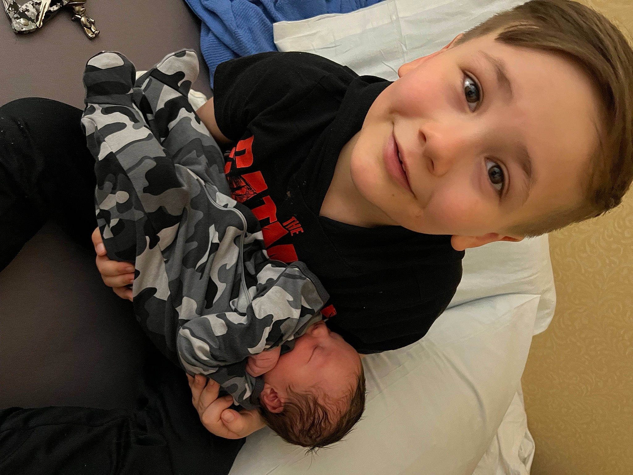 Brandon is registered to the contest to win money with this photo: abdomen, baby, child, comfort, elbow, facial_expression, finger, fun, gesture, happy, human_body, joint, joy, leg, pattern, person, sitting, sleeve, smile, thigh