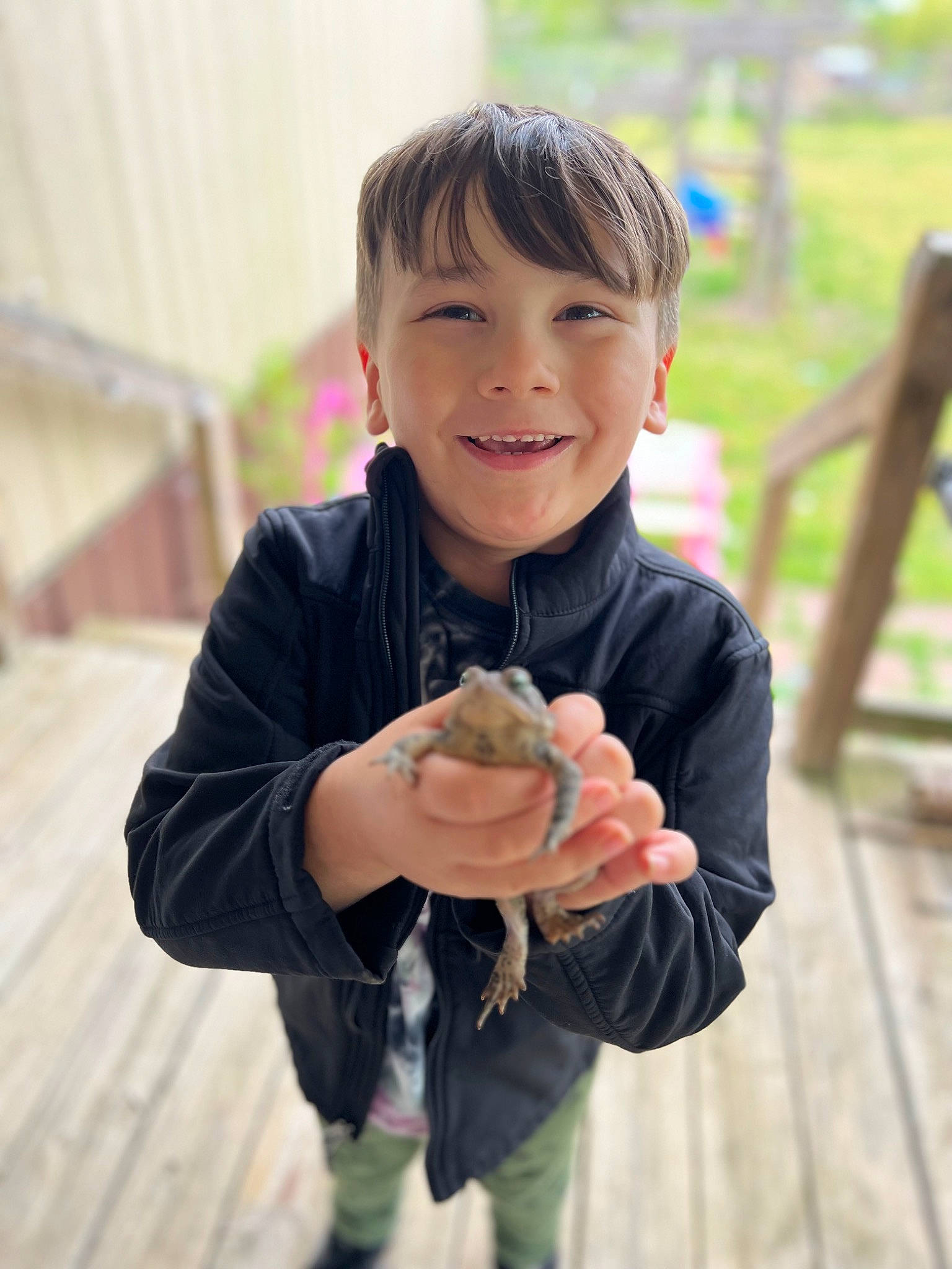 Brandon is registered to the contest to win money with this photo: baby_toddler_clothing, child, food, fun, gesture, grass, hand, happy, joy, laugh, leisure, people_in_nature, person, plant, portrait_photography, sitting, sleeve, smile, thumb, toddler