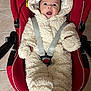 Zoé participe au concours pour gagner de l'argent avec cette photo : baby, infant, car_seat, red, onesie, fluffy_clothing, smiling, happy, child, indoors, seatbelt, toddler, cute, cozy, warm_clothing, face, person, headwear, floor, tile