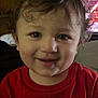 toddler, child, smiling, curly_hair, red_shirt, indoor, portrait, face, happy, person, clothing, wall_art, moon_phases, background, television, light, young_child, casual, cute, expression