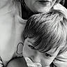 Jasiah is registered to the contest to win money with this photo: woman, child, pacifier, black_and_white, portrait, intimacy, close_up, face, hair, skin, hand, expression, tenderness, candid, indoor, sweatshirt, childhood, family, love, affection