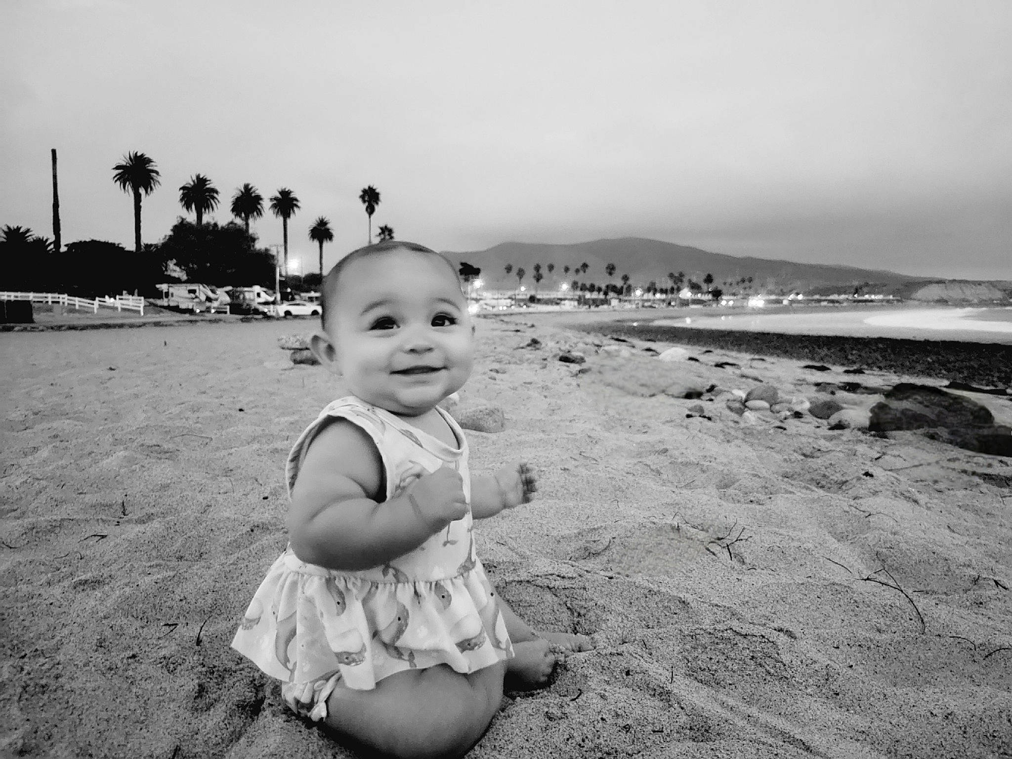 Davina is registered to the contest to win money with this photo: baby, beach, black, black_and_white, child, flash_photography, fun, happy, horizon, joy, monochrome, monochrome_photography, palm_tree, people, people_in_nature, person, sky, smile, style, toddler