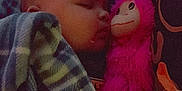 Mateo is registered to the contest to win money with this photo: baby, bedtime, blanket, child, comfort, cozy, cuddling, cute, indoor, infant, monkey_toy, peaceful, pink, plaid, portrait, resting, sleeping, soft_lighting, toy, warm