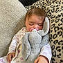 Naveah joined the competition — help win amazing prizes! baby, sleeping, pacifier, stuffed_animal, plush_toy, couch, cushion, onesie, infant, hand, face, child, soft_toy, comfort, rest, cute, indoors, nap, cozy, patterned_fabric