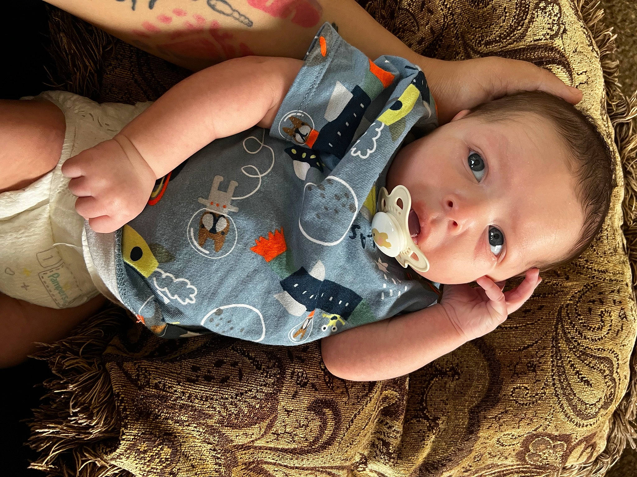 Maverick is registered to the contest to win money with this photo: baby, baby_toddler_clothing, cheek, child, cool, fashion_accessory, finger, fun, gesture, grass, happy, human_leg, iris, nail, pattern, person, sitting, skin, thumb, toddler