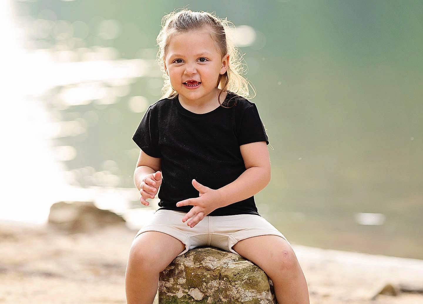 Lindsay joined the competition — help win amazing prizes! barefoot, blond, child, flash_photography, fun, grass, happy, human_leg, knee, leg, people_in_nature, person, sand, shorts, sitting, sleeve, smile, t_shirt, thigh, toddler