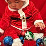 Jayden a rejoint le concours — aidez-le/la à gagner de superbes lots ! baby, child, christmas, santa_claus, red_clothing, white_trim, hat, ornaments, holiday, festive, glossy_balls, red_blanket, sitting, cute, winter, celebration, decorations, glitter, white_socks, holiday_spirit