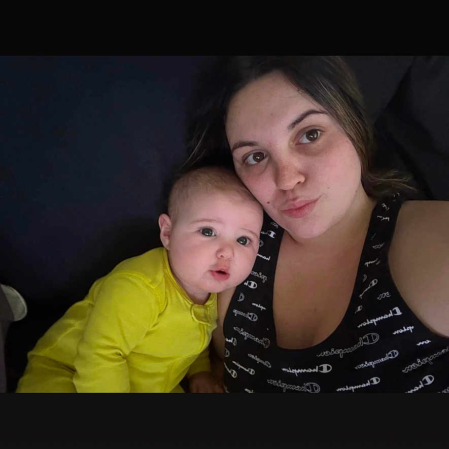 Delaney is registered to the contest to win money with this photo: baby, casual, child, closeup, couch, face, family, happy, head_and_shoulders, home, indoor, infant, person, portrait, relaxing, selfie, toddler, woman, yellow_clothing, young_adult