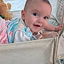 Marian joined the competition — help win amazing prizes! baby, infant, crib, mesh, blanket, plush_toy, teddy_bear, smiling, happy, child, face, blue_eyes, cute, clothing, soft_toys, indoor, portrait, laying_down, baby_girl, playpen