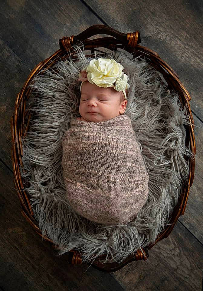 Lea is registered to the contest to win money with this photo: baby, baby_toddler_clothing, bonnet, costume_accessory, fur, hair_accessory, headband, headgear, headpiece, headwear, knitting, person, portrait, portrait_photography, rose, thread, wool, woolen