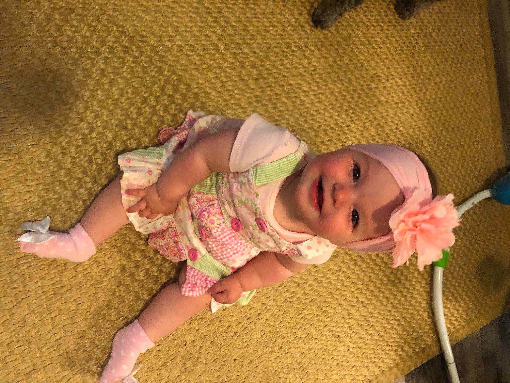 June is registered to the contest to win money with this photo: baby, baby_products, baby_safety, baby_toddler_clothing, cheek, child, comfort, eye, finger, flooring, happy, head, headwear, joy, linens, mouth, nose, person, pink, skin