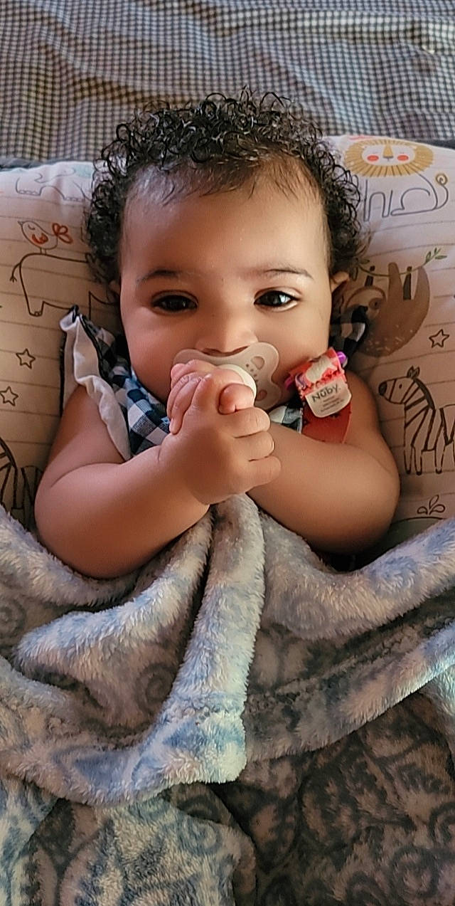 Legacy is registered to the contest to win money with this photo: arm, baby_toddler_clothing, cheek, chin, ear, eye, eyebrow, eyelash, face, hair, hairstyle, hand, happy, head, iris, lip, mouth, nose, person, photograph