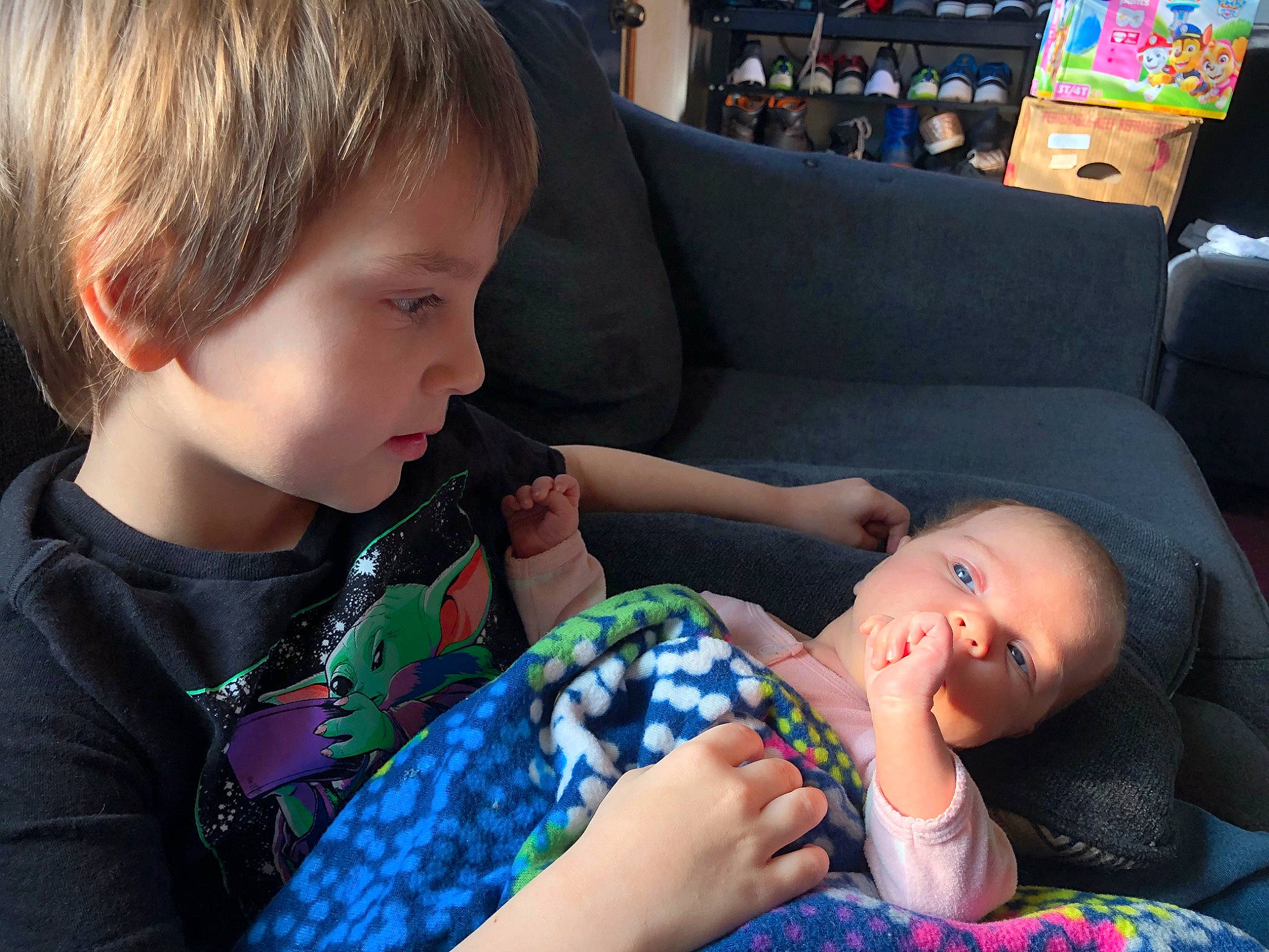 Ayden is registered to the contest to win money with this photo: arm, child, comfort, cool, couch, design, fun, hairstyle, happy, human, lap, leisure, mammal, pattern, person, plaid, sitting, t_shirt, thigh, toddler