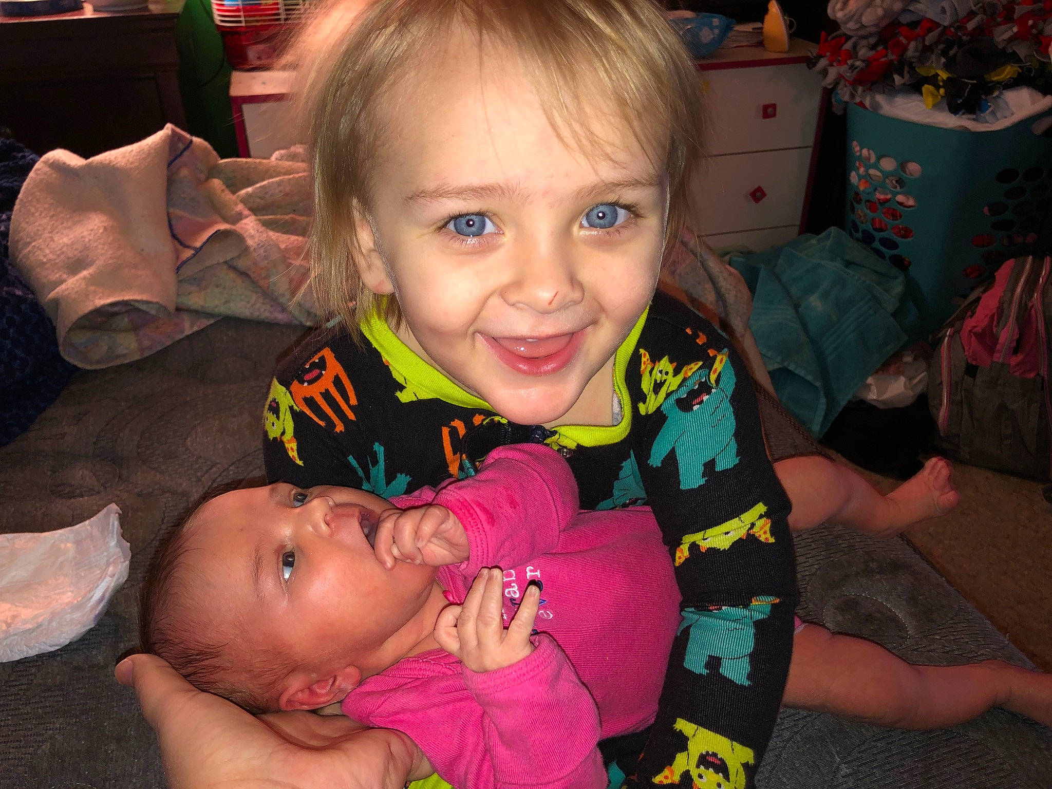 Bryson is registered to the contest to win money with this photo: baby, baby_toddler_clothing, cheek, child, event, finger, fun, happy, head, iris, joy, lap, mouth, nose, people, person, shipping_box, sitting, skin, smile