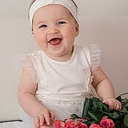 Kristina joined the competition — help win amazing prizes! baby, smiling, headband, flower, roses, bouquet, white_clothing, happy, cute, infant, portrait, sitting, hands, feet, skin, indoors, soft_light, tulle, flower_decoration, child