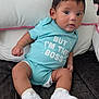Nicolas is registered to the contest to win money with this photo: baby, casual, child, comfortable, couch, curious, cushion, cute, expression, face, indoor, infant, onesie, person, pink_trim, portrait, sitting, turquoise_clothing, white_sneakers, young_child