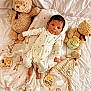 Nicolas joined the competition — help win amazing prizes! baby, bed, blanket, child, cute, decor, face, foot, hand, head, indoors, infant, lying_down, milestone, onesie, plush_toy, smiling, soft_toy, teddy_bear, wooden_sign