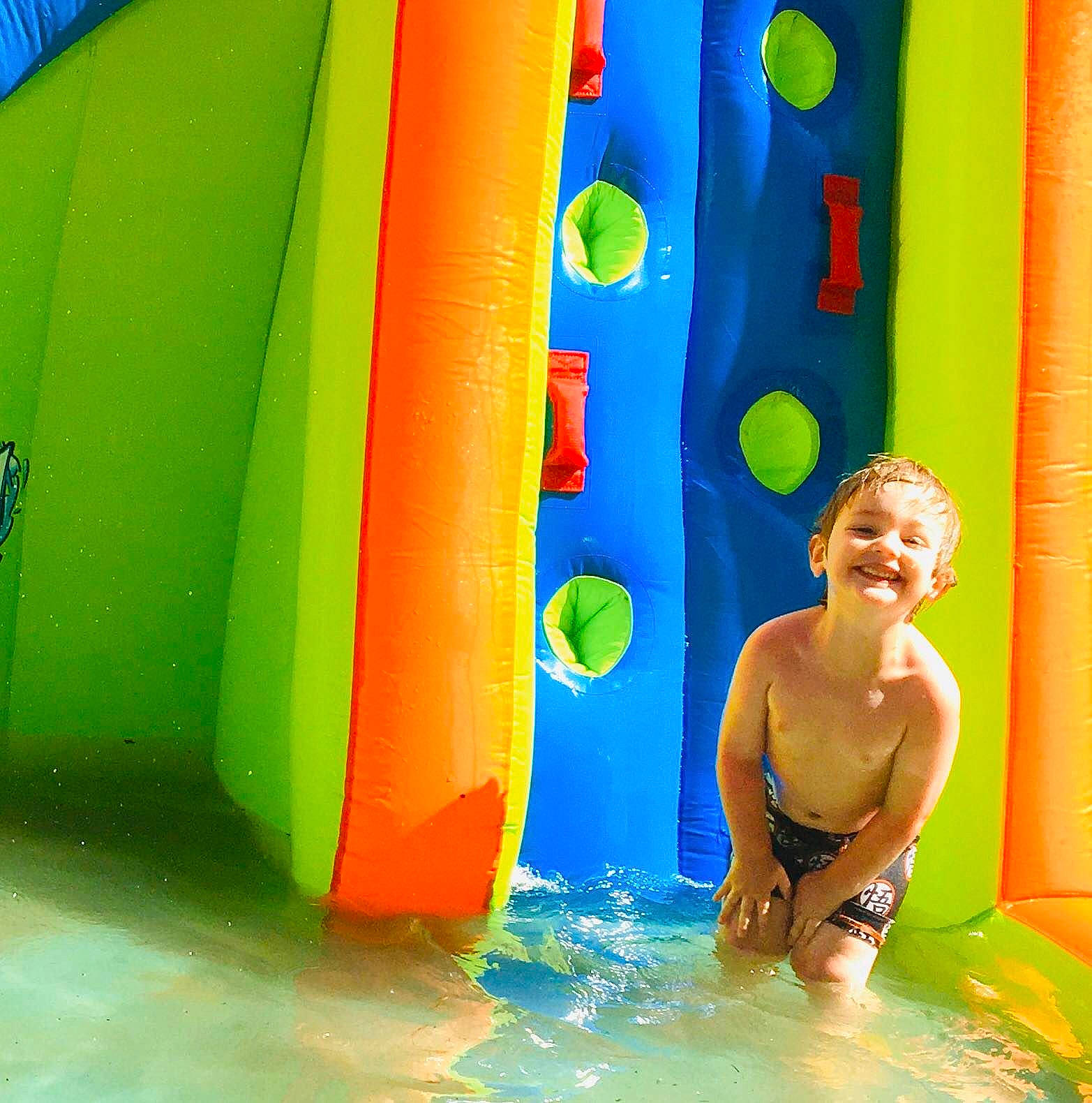 Abel is registered to the contest to win money with this photo: amusement_park, aqua, azure, bathing, blue, chute, colorfulness, fun, inflatable, joy, leisure, leisure_centre, majorelle_blue, nonbuilding_structure, person, play, recreation, summer, swimwear, vacation