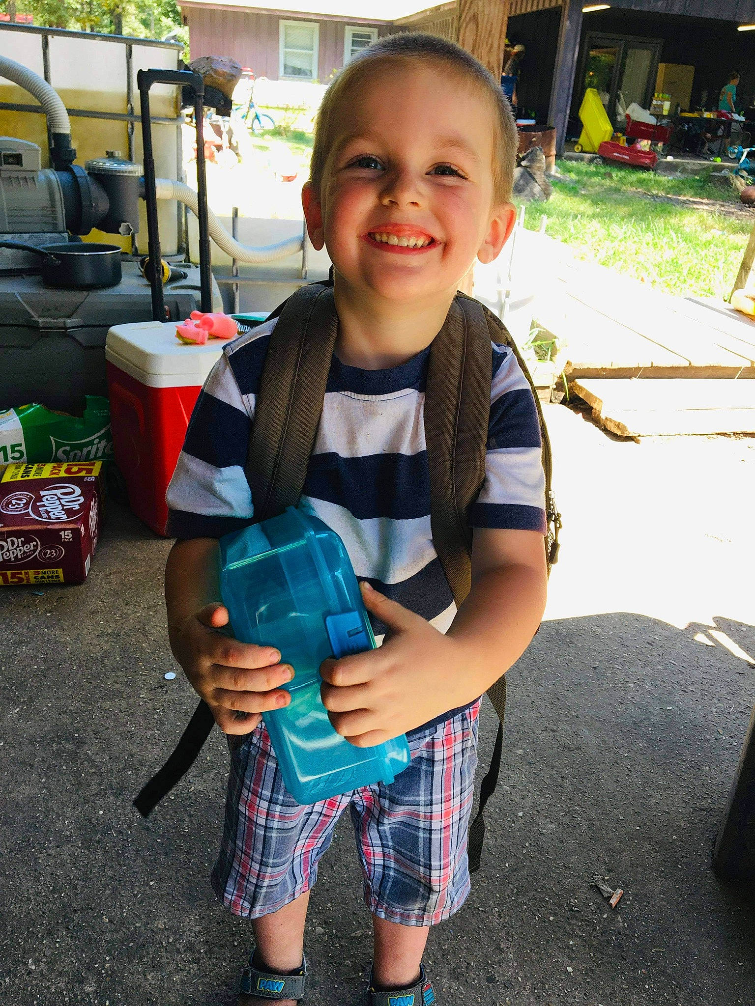 Abel is registered to the contest to win money with this photo: baby_toddler_clothing, bag, box, child, flip_flops, joy, luggage_and_bags, person, plaid, sandal, slipper, sock, stuffed_toy, tartan, toddler, yard