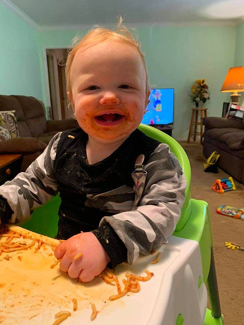 Tarek is registered to the contest to win money with this photo: baby, baby_laughing, baby_toddler_clothing, child, couch, home, houseplant, interior_design, kitchen_utensil, lamp, lampshade, laugh, living_room, person, picture_frame, play, room, television, toddler, tongue