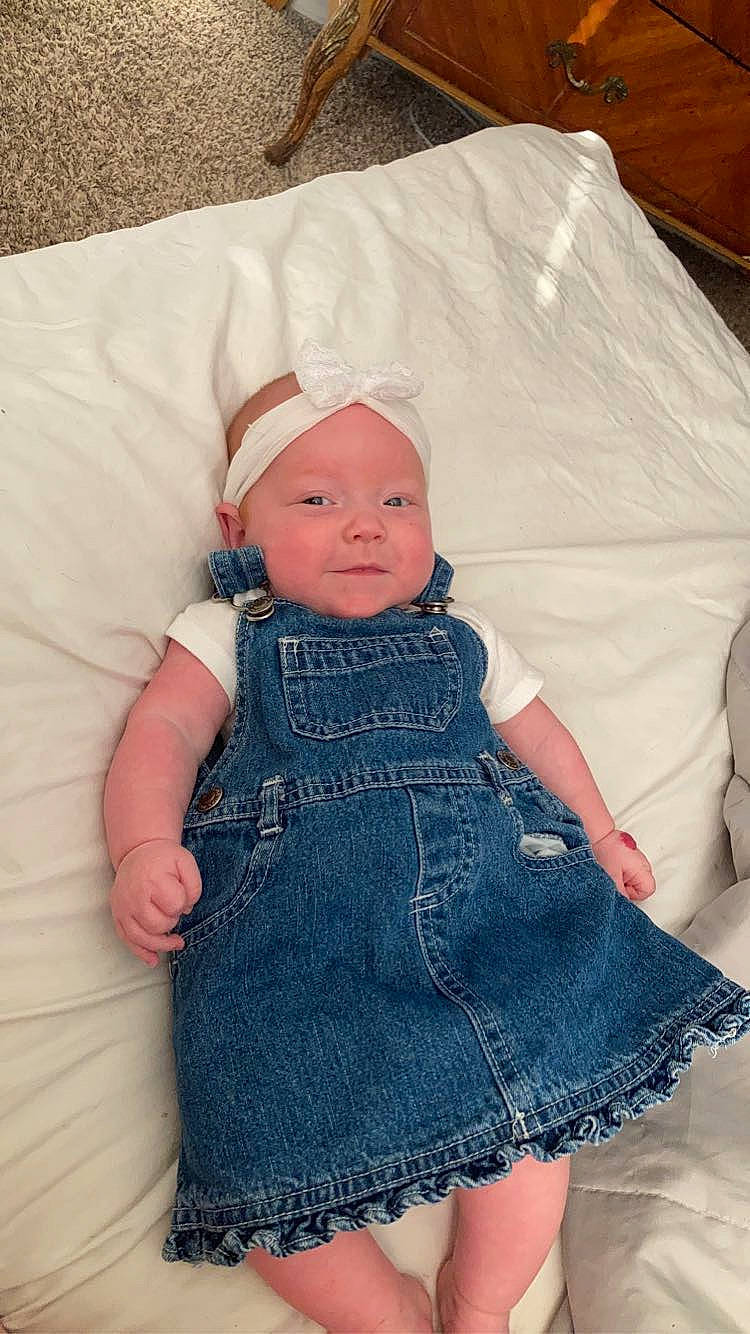 Savanna is registered to the contest to win money with this photo: baby, baby_toddler_clothing, cap, child, cocktail_dress, day_dress, denim, dress, electric_blue, embellishment, face, fashion_accessory, headwear, one_piece_garment, outerwear, pattern, person, pink, skin, sleeve