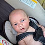 Isaiah is registered to the contest to win money with this photo: baby, infant, car_seat, straps, warning_label, child, seat_belt, close_up, skin, face, head, hand, expression, indoor, safety, padded, young, person, seat, restraint