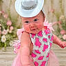baby, child, cowboy_hat, pink_dress, sparkles, floral_background, fluffy_rug, cute, portrait, indoor, fashion, tutu, happy, smiling, baby_boots, infant, playful, costume, adorable, person
