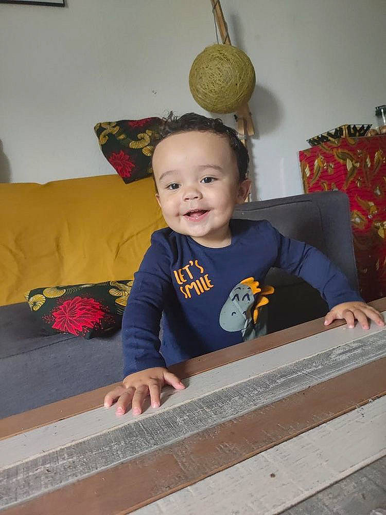 Cody participe au concours pour gagner de l'argent avec cette photo : baby, baby_toddler_clothing, child, comfort, couch, flooring, fun, happy, hardwood, joy, linens, living_room, person, product, rectangle, room, sitting, smile, t_shirt, textile