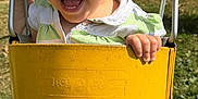Evie is registered to the contest to win money with this photo: toddler, child, swing, yellow_swing, outdoor, playground, happy, smiling, grass, daylight, jeans, green_shirt, short_hair, holding, fun, sunny, park, metal_chains, casual_clothing, joy