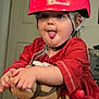 Evie is registered to the contest to win money with this photo: toddler, child, helmet, red_clothing, stuffed_animal, indoor, playful, tongue_out, toy, minnie_mouse, leggings, cute, smiling, face, person, young_child, helmet_strap, plush_toy, door, casual_wear
