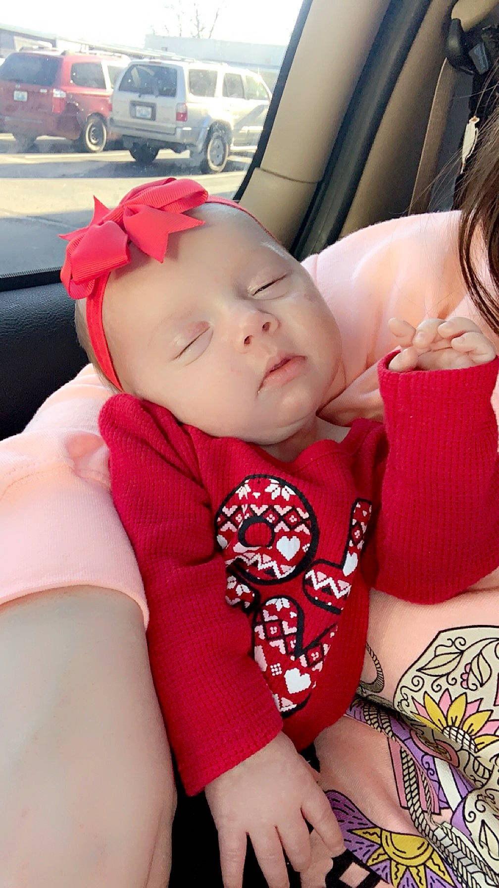 Raelynn is registered to the contest to win money with this photo: auto_part, baby, baby_toddler_clothing, car_seat, child, comfort, finger, happy, hat, headwear, human_leg, joint, pattern, person, sitting, skin, sleeve, thigh, toddler, trunk