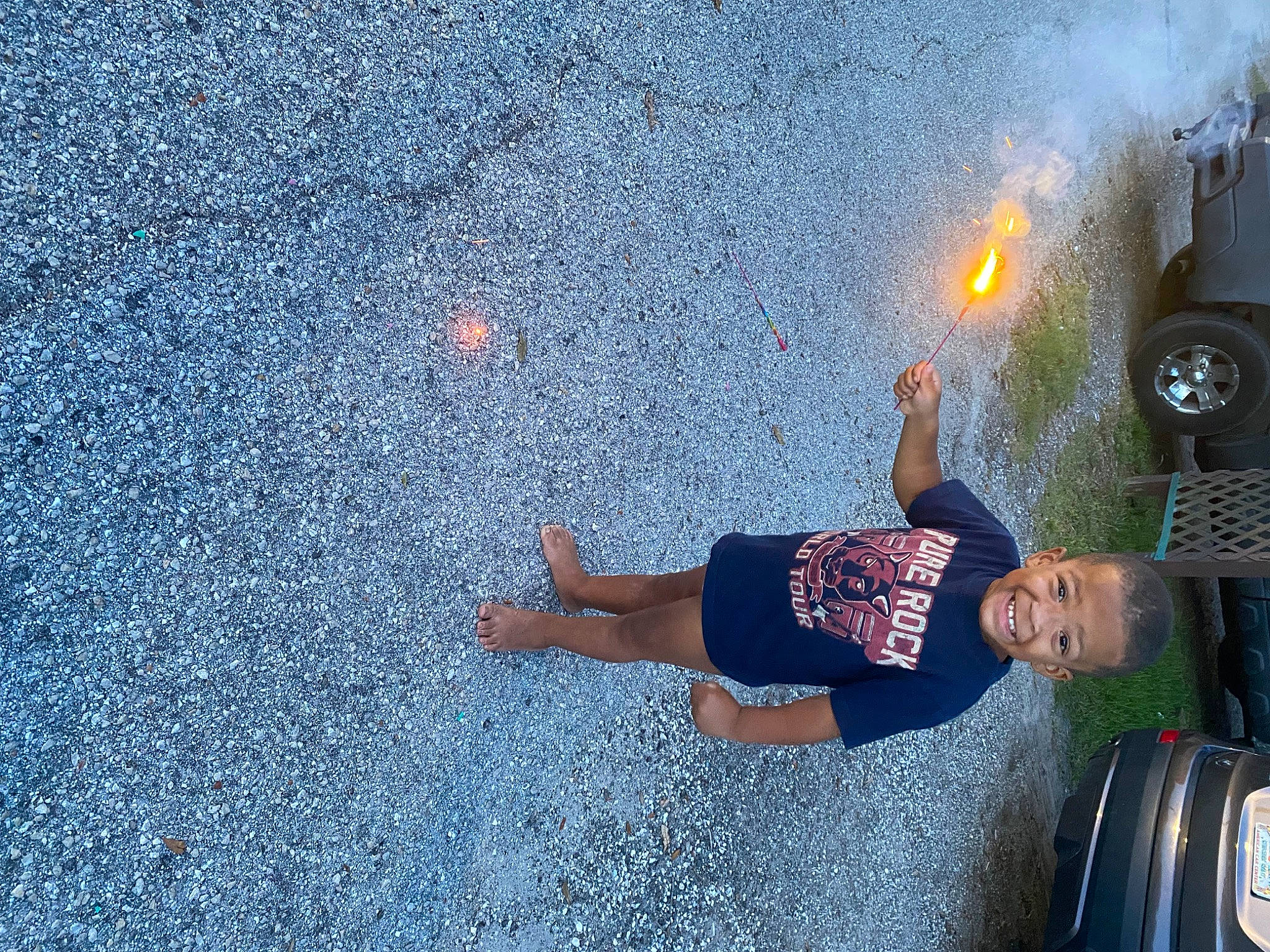 Christopher is registered to the contest to win money with this photo: asphalt, automotive_exterior, automotive_lighting, automotive_tire, car, electric_blue, fun, grass, human_leg, joy, leg, leisure, person, road, road_surface, sidewalk, tints_and_shades, tire, vehicle_door, wall