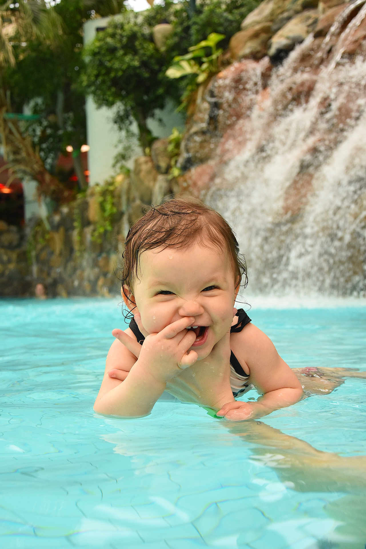 Luna participe au concours pour gagner de l'argent avec cette photo : toddler, child, pool, water, splash, wet_hair, playful, smiling, waterfall, outdoor, summer, fun, happy, person, swimming, cute, nature, recreation, leisure, portrait