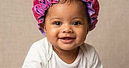 Carebear is registered to the contest to win money with this photo: baby, bonnet, child, closeup, cuddly, cute, face, happy, headwear, indoor, infant, person, plush_toy, portrait, purple_toy, smiling, soft_texture, toy, white_clothing, young_child