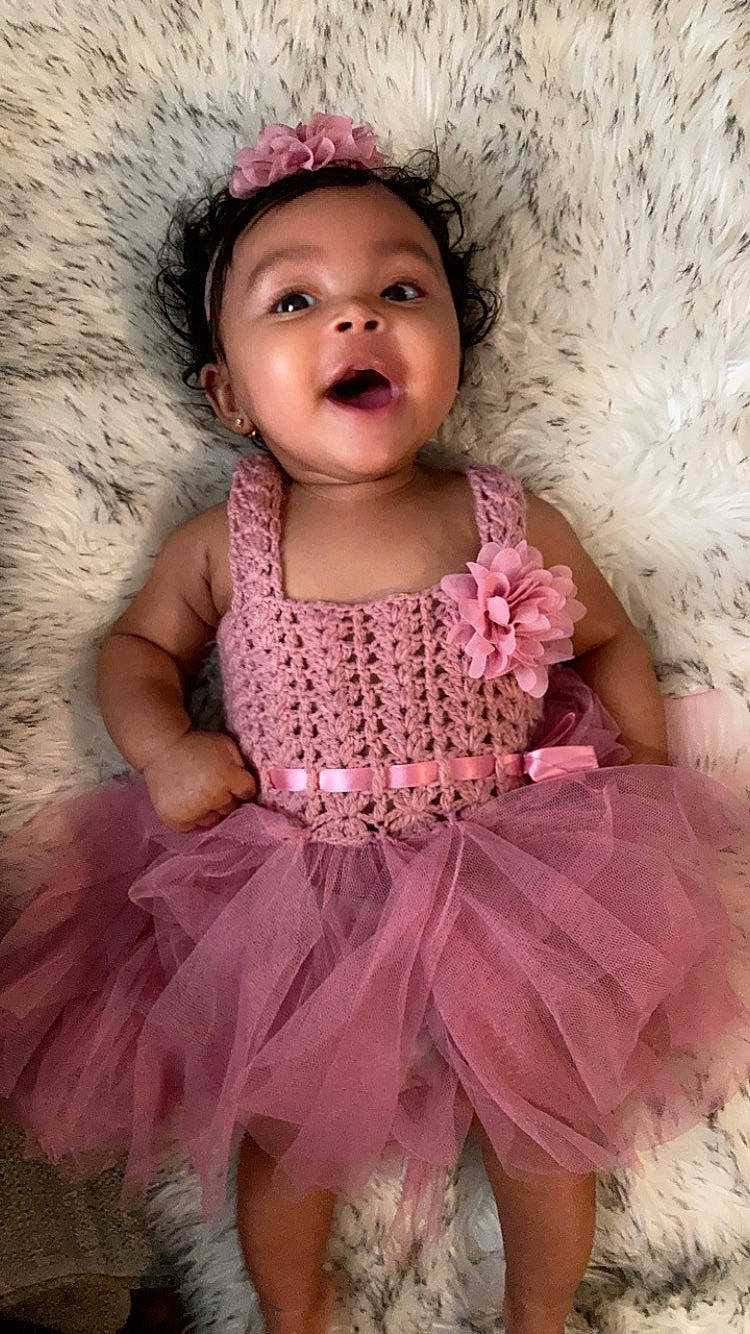 Davina is registered to the contest to win money with this photo: arm, baby_toddler_clothing, beauty, day_dress, dress, embellishment, eye, face, flash_photography, happy, head, iris, magenta, person, pink, purple, skin, sleeve, smile, toddler