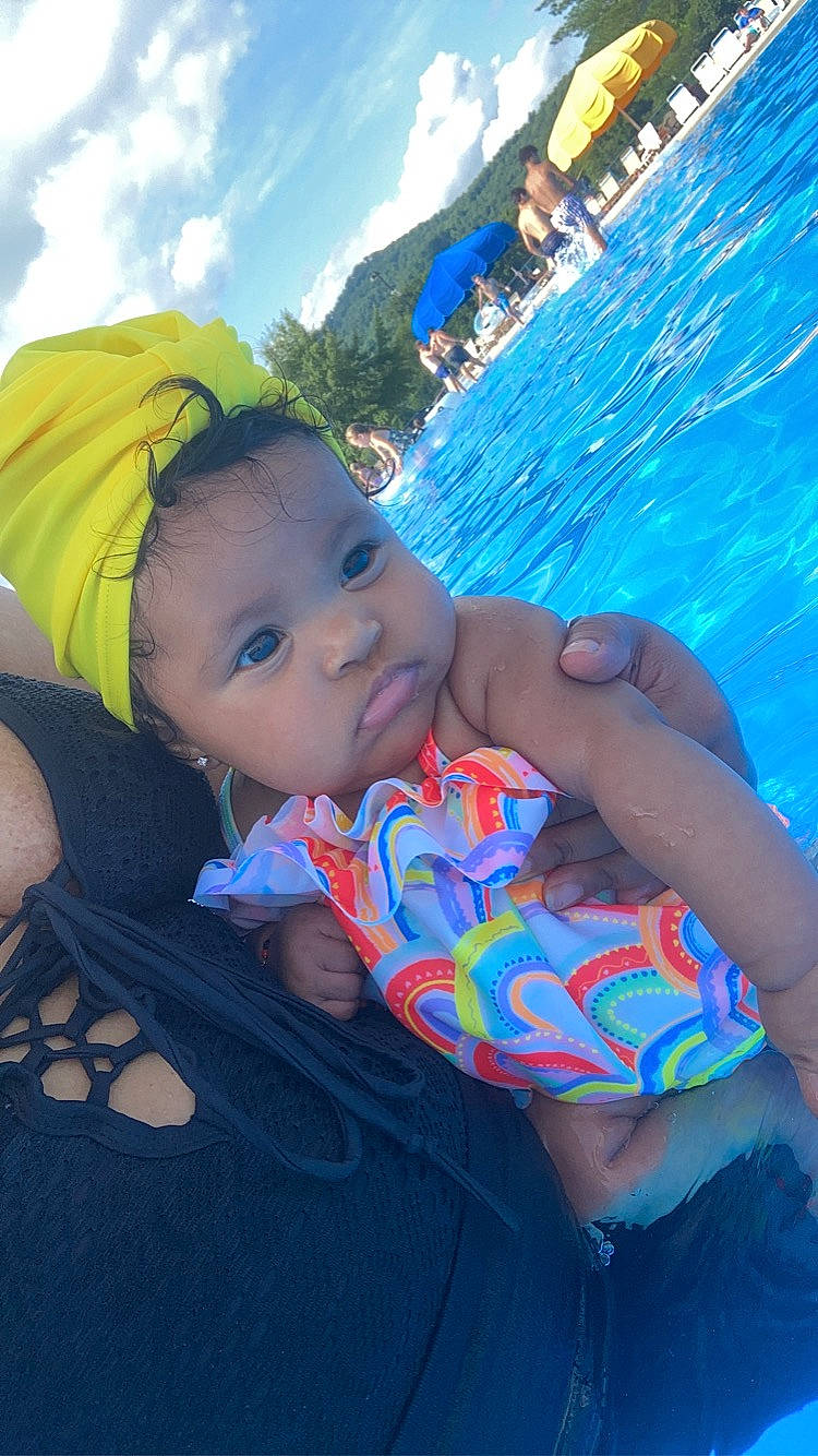 Davina is registered to the contest to win money with this photo: azure, baby, baby_products, baby_toddler_clothing, blue, child, cloud, electric_blue, fun, grass, happy, leisure, pattern, person, recreation, sitting, sky, swimming_pool, toddler, vacation