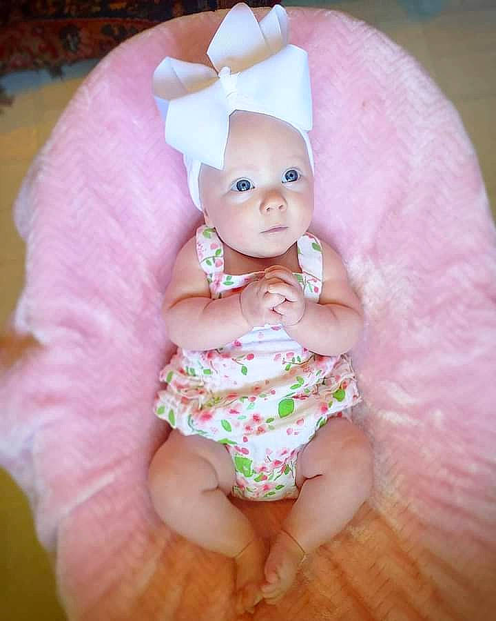 Chandler is registered to the contest to win money with this photo: baby, baby_products, baby_toddler_clothing, cheek, child, eye, hair_accessory, head, headgear, lip, person, pink, product, skin, smile, toddler