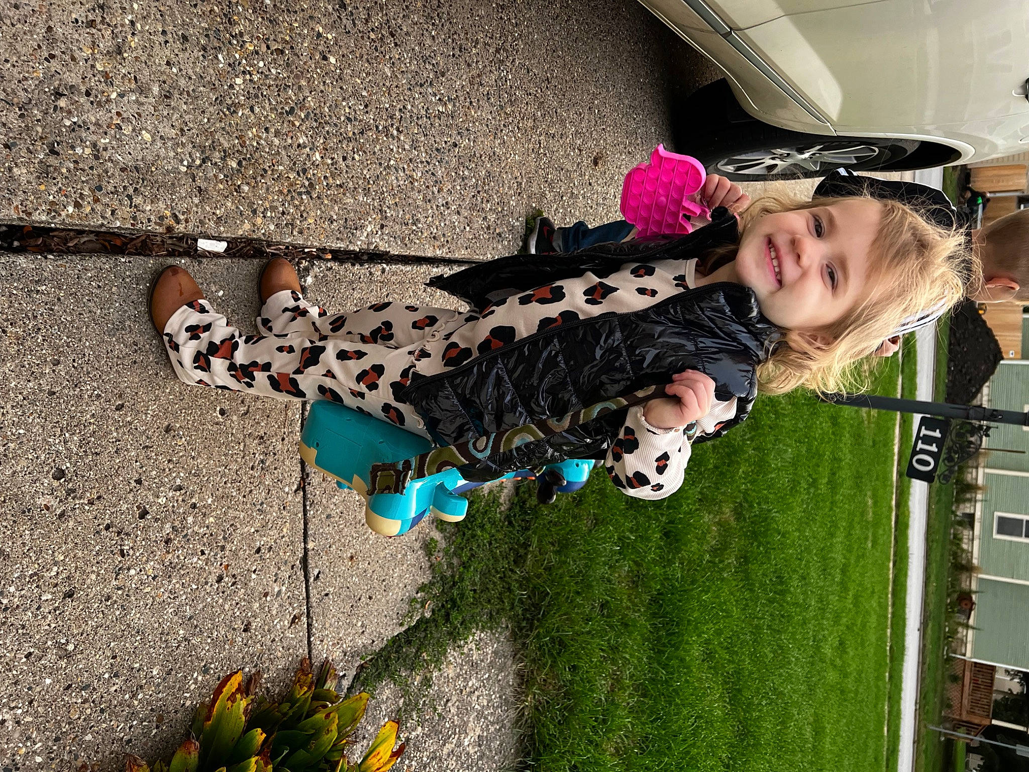 Delilah joined the competition — help win amazing prizes! asphalt, child, concrete, electric_blue, fun, grass, happy, joy, leisure, people_in_nature, person, plant, road_surface, shadow, sidewalk, smile, soil, toddler