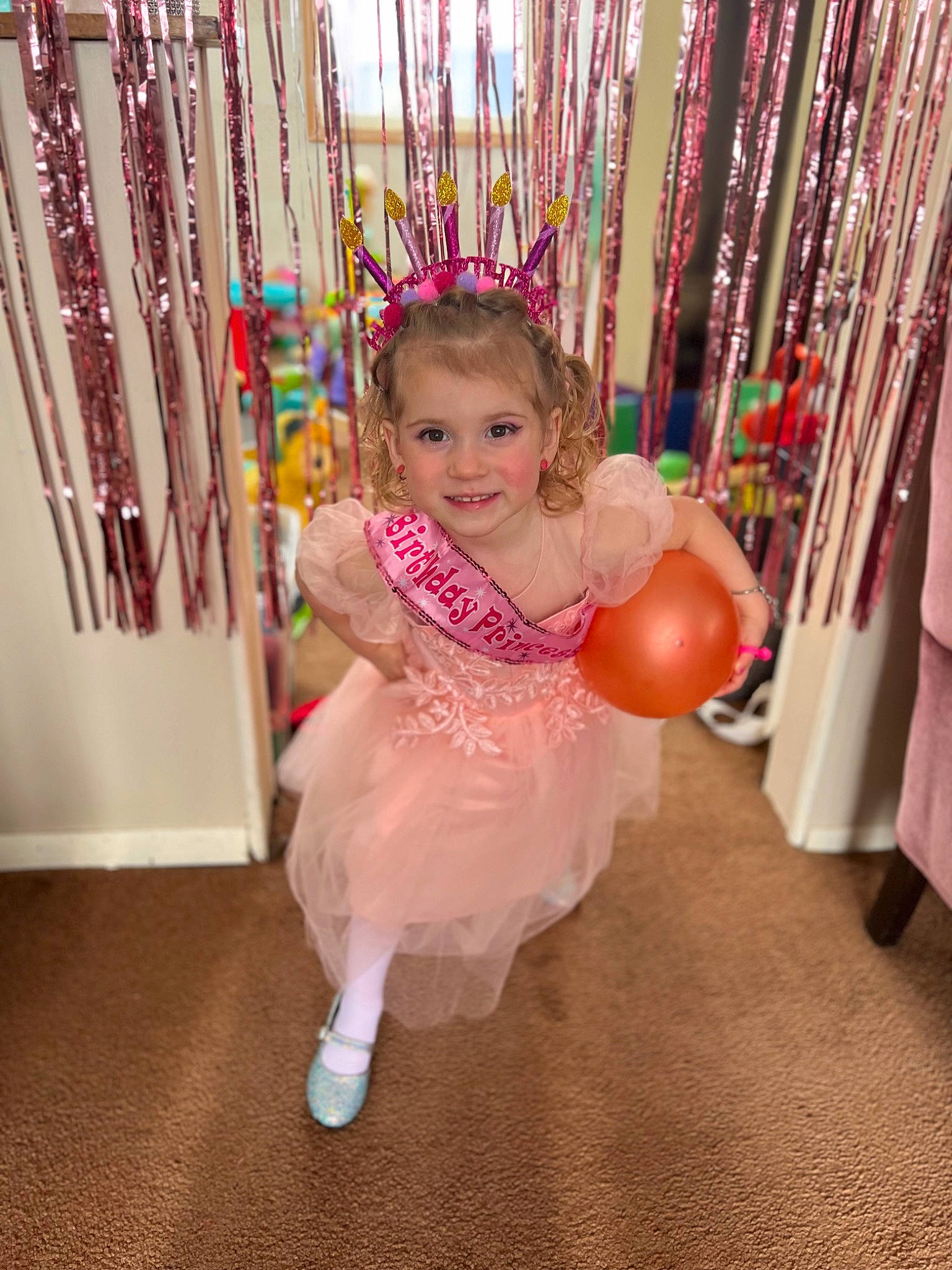 Delilah is registered to the contest to win money with this photo: baby, baby_toddler_clothing, balloon, birthday, child, dress, event, face, facial_expression, formal_wear, fun, happy, joy, leisure, magenta, party, party_supply, person, pink, room