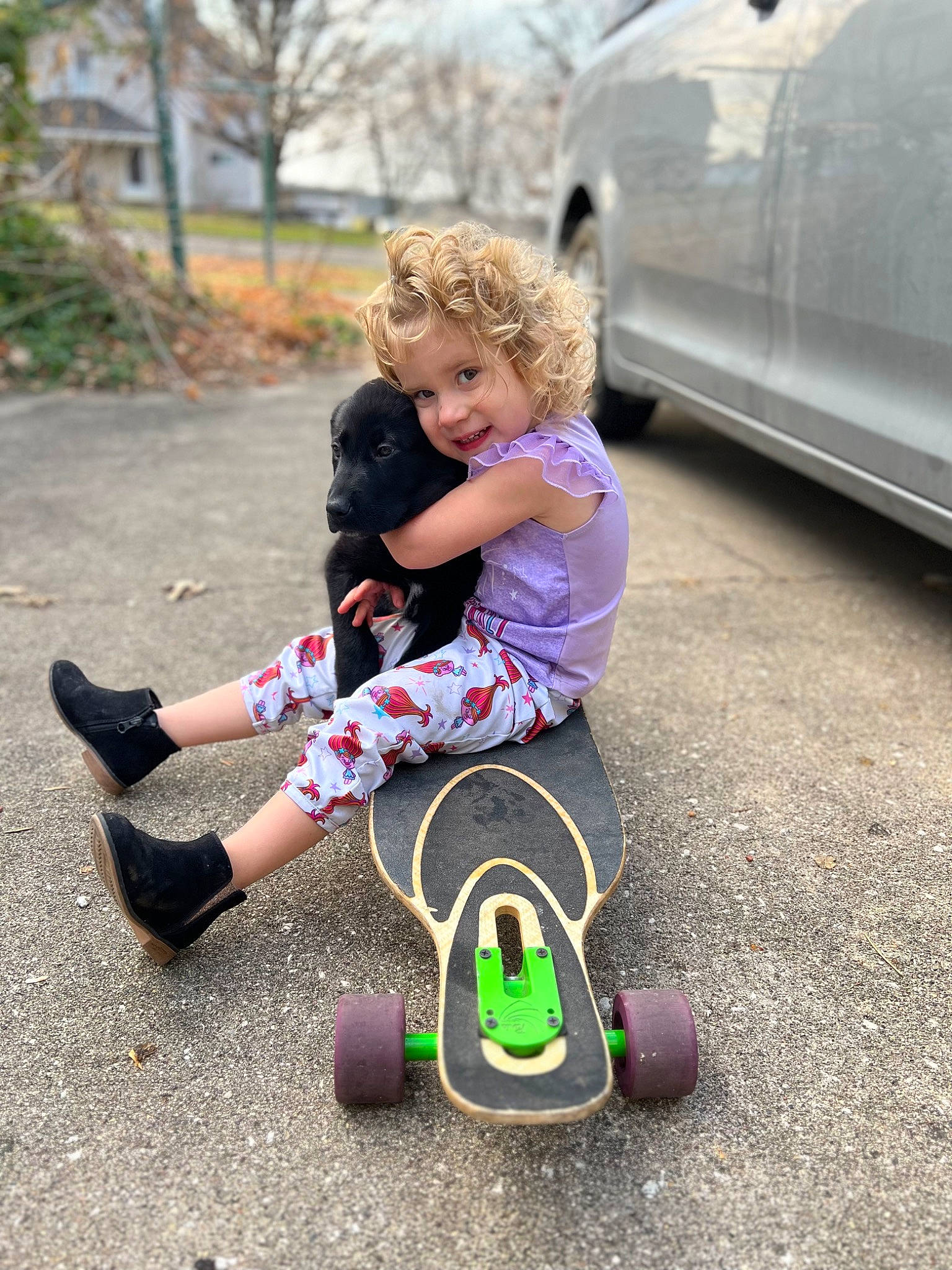 Delilah is registered to the contest to win money with this photo: asphalt, automotive_design, automotive_lighting, automotive_tire, automotive_wheel_system, car, grass, happy, leisure, motor_vehicle, person, plant, recreation, rolling, smile, tire, toddler, tree, vehicle, vehicle_door