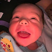 Andrew joined the competition — help win amazing prizes! baby, close_up, smiling, happy, infant, face, blanket, cute, mouth_open, joyful, child, portrait, indoors, soft_lighting, warm_colors, newborn, expression, clothing, wrapped, person