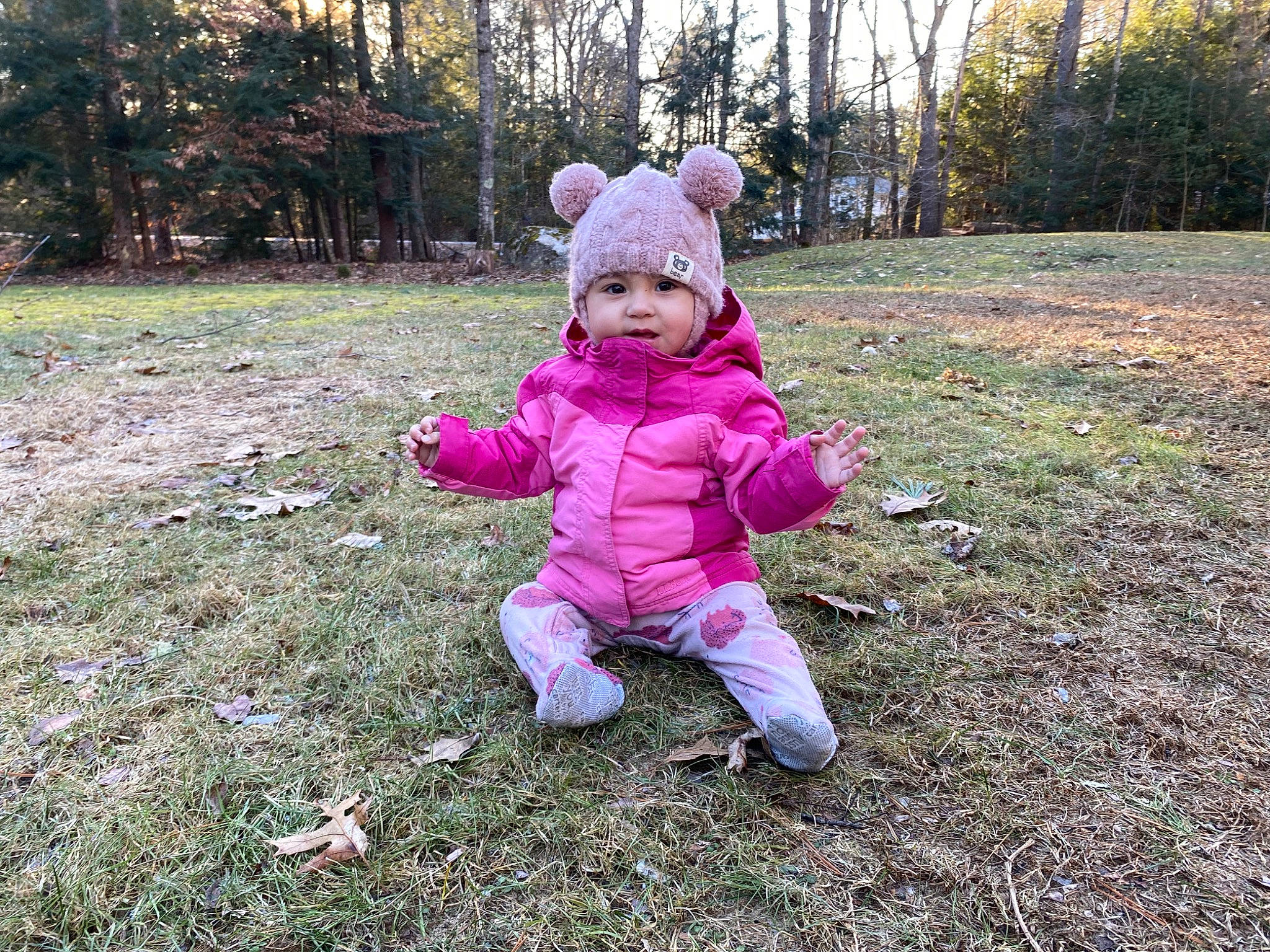 Rosie is registered to the contest to win money with this photo: baby, baby_toddler_clothing, child, eye, fur, garden, grass, grassland, happy, headwear, landscape, lawn, magenta, people_in_nature, person, plant, sitting, soil, toddler, tree