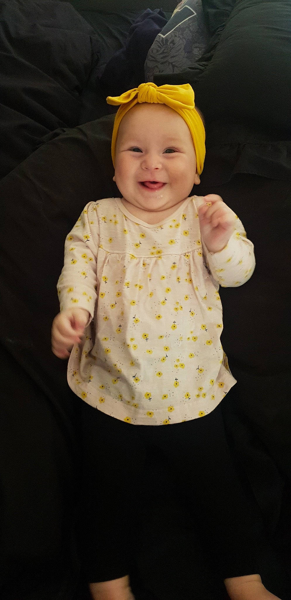 Alaska is registered to the contest to win money with this photo: baby, baby_toddler_clothing, child, design, dress, head, headgear, headwear, joy, outerwear, pattern, person, product, sleeve, smile, toddler, yellow