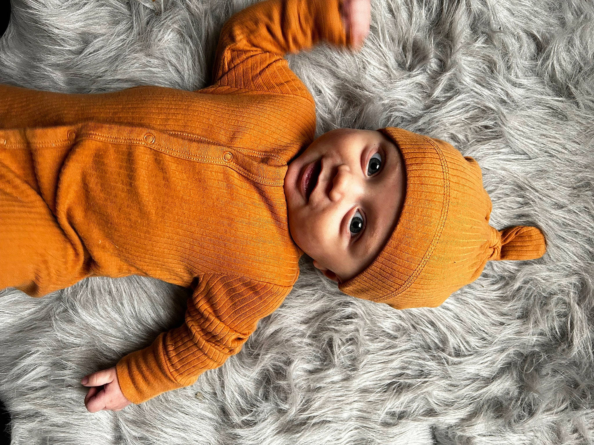 Marcello is registered to the contest to win money with this photo: baby, cheek, chin, comfort, eye, eyebrow, eyelash, fur, grass, happy, hat, head, headgear, headwear, lip, mouth, nose, orange, person, skin