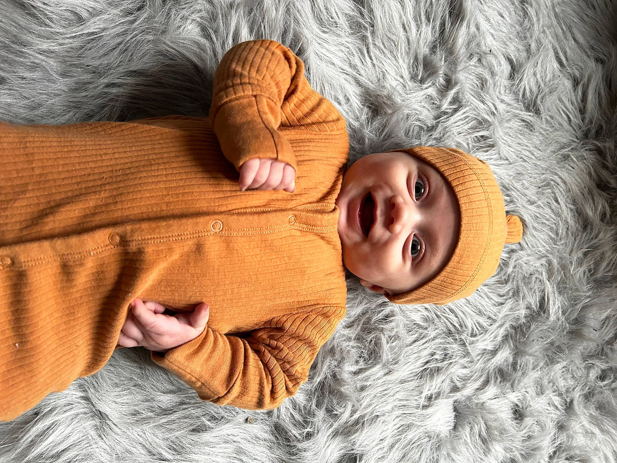 Marcello is registered to the contest to win money with this photo: baby, bedding, bedtime, child, comfort, eye, flooring, fur, happy, headwear, linens, mouth, nose, person, room, skin, smile, textile, toddler, wood