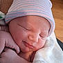 baby, blanket, child, closeup, cute, face, hand, hat, indoors, infant, newborn, newborn_hat, peaceful, portrait, resting, skin, sleeping, soft, warm, wrapped