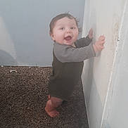 Milo joined the competition — help win amazing prizes! baby, carpet, child, clothing, cute, expression, face, feet, hands, happy, home, indoor, infant, long_sleeve, looking, person, smile, standing, wall, young